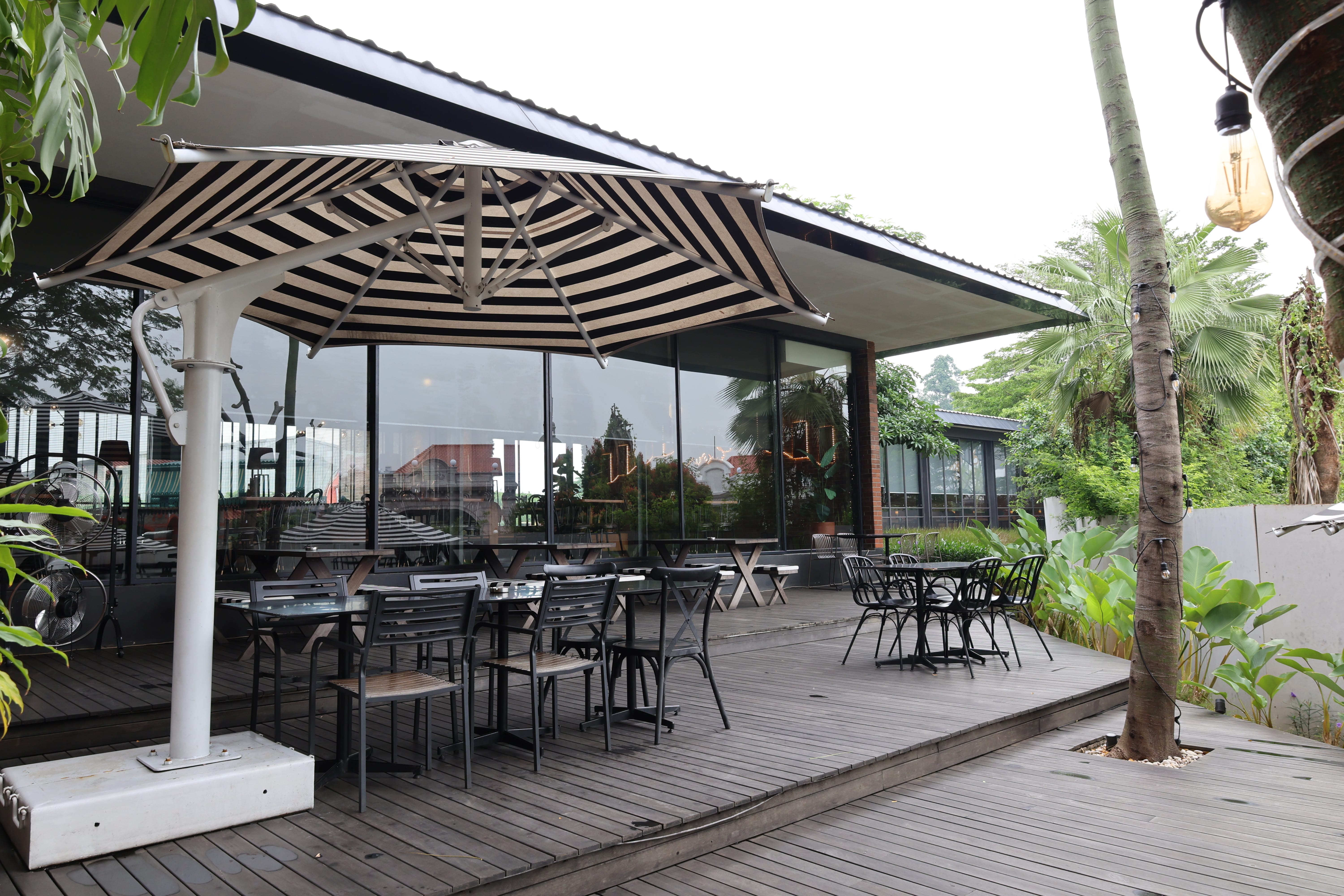 Outdoor hardwood decking at BSteak Kelapa Gading with garden setting by Reywood Indonesia